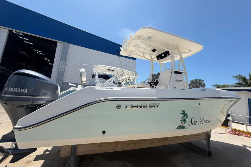 Slide: The Image of 2016 Century 2301 Center Console boat with Yamaha engine, docked outdoors. - 12