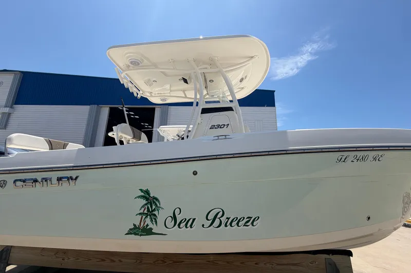 Slide: The Image of 2016 Century 2301 Center Console boat named "Sea Breeze" under clear blue sky. - 13