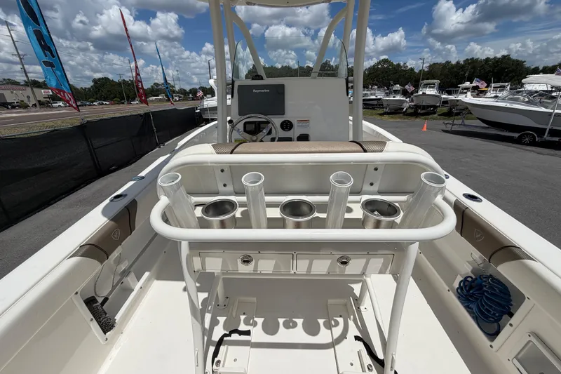 Slide: The Image of 2016 Century 2301 Center Console boat interior with rod holders and steering console. - 14