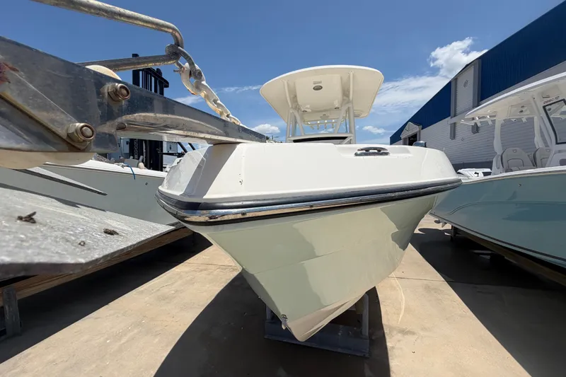 Slide: The Image of 2016 Century 2301 Center Console boat on display under clear blue sky. - 16