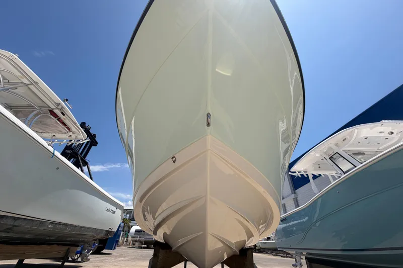 Slide: The Image of 2016 Century 2301 Center Console boat displayed outdoors under clear blue sky. - 17