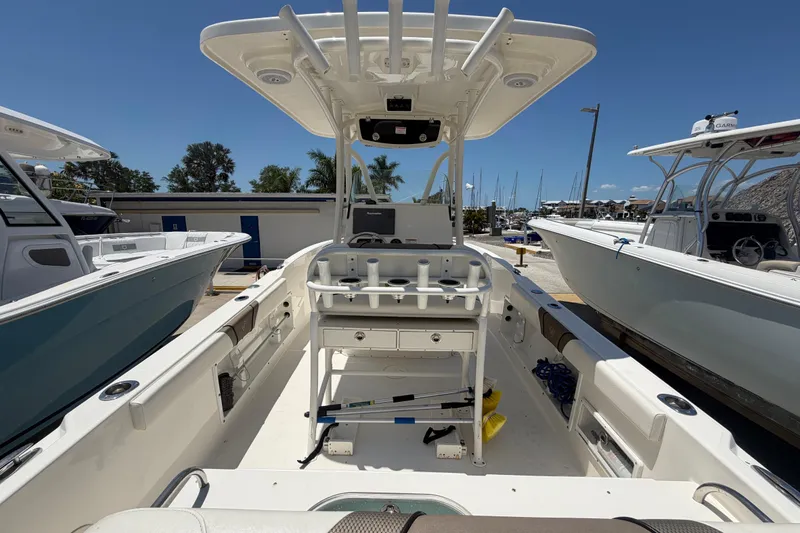 Slide: The Image of 2016 Century 2301 Center Console boat docked, showcasing spacious deck and seating area. - 19