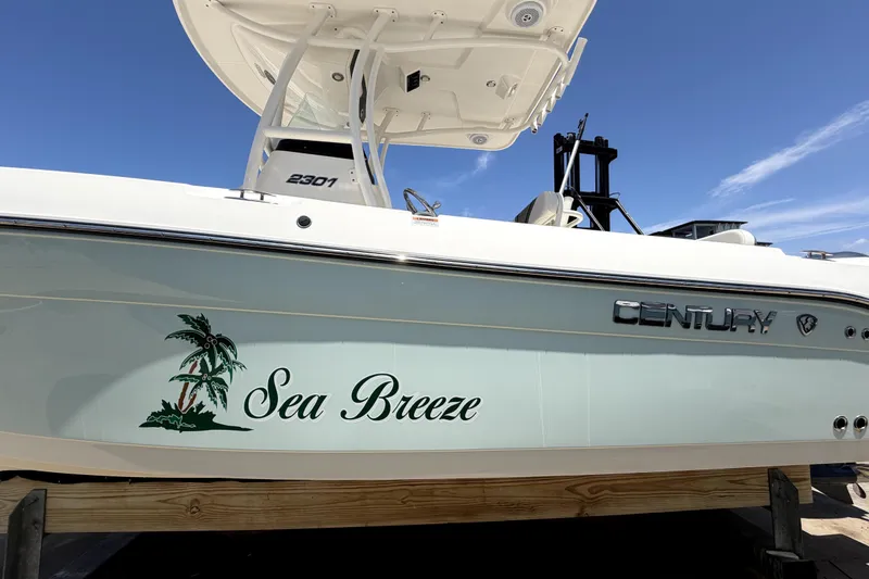 Slide: The Image of Century 2301 Center Console boat, 2016 model, named "Sea Breeze" with palm tree graphic. - 2