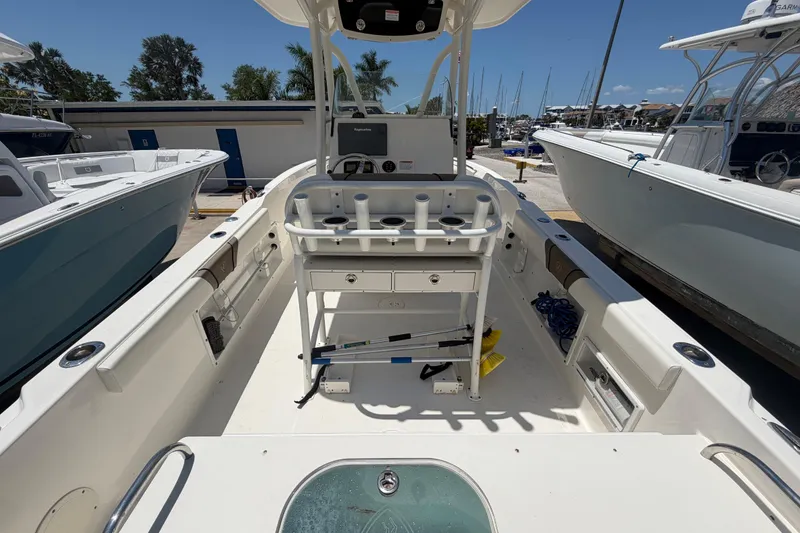 Slide: The Image of 2016 Century 2301 Center Console boat interior with fishing rod holders and helm station. - 21