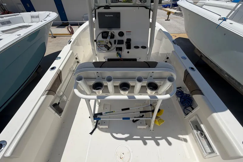 Slide: The Image of 2016 Century 2301 Center Console boat interior with steering wheel and rod holders. - 22