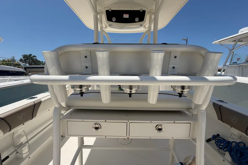 Slide: The Image of 2016 Century 2301 Center Console boat interior with rod holders and storage compartments. - 24