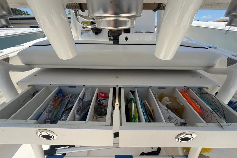Slide: The Image of Tackle storage on a 2016 Century 2301 Center Console boat, featuring organized fishing gear compartments. - 25
