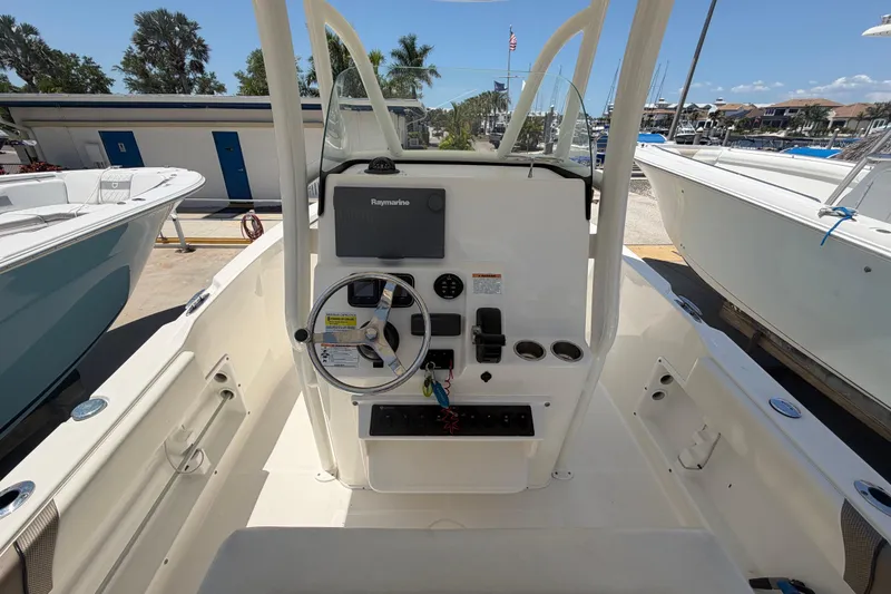 Slide: The Image of 2016 Century 2301 Center Console boat interior with steering wheel and navigation system. - 28