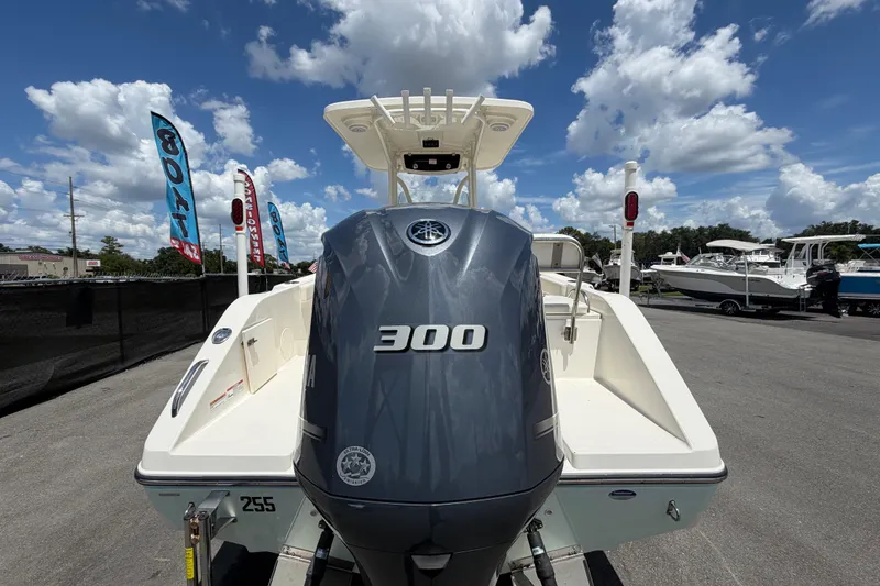 Slide: The Image of 2016 Century 2301 Center Console boat with Yamaha 300 engine, displayed outdoors. - 3