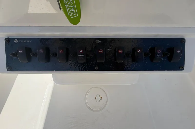 Slide: The Image of Control panel of a 2016 Century 2301 Center Console boat with multiple switches. - 33