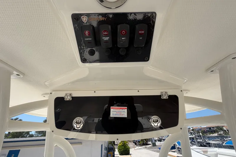 Slide: The Image of Century 2301 Center Console 2016 boat dashboard with control panel and storage compartment. - 38