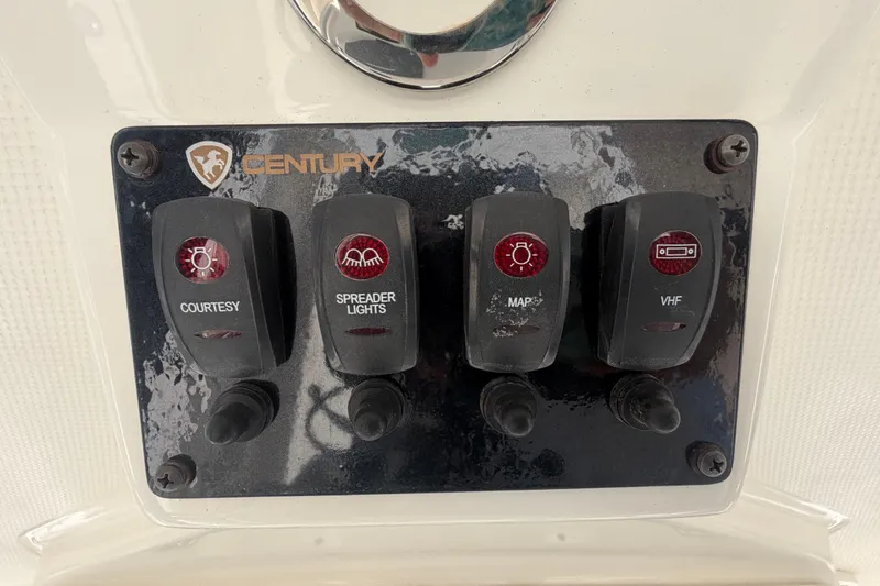 Slide: The Image of Control panel of a 2016 Century 2301 Center Console boat with labeled switches. - 39