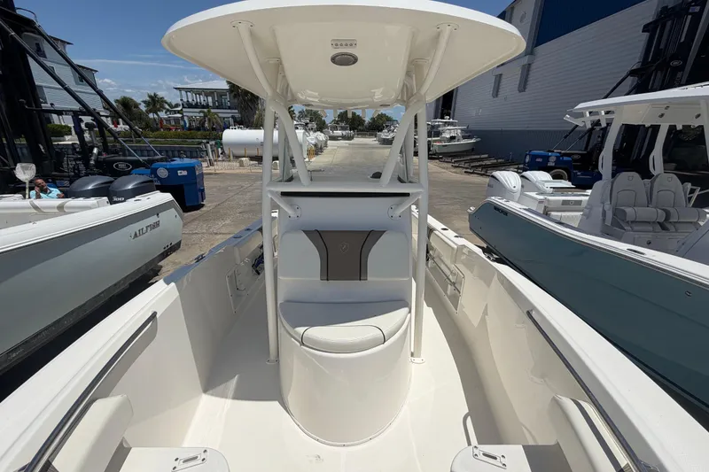Slide: The Image of 2016 Century 2301 Center Console boat docked, showcasing spacious seating and modern design. - 52