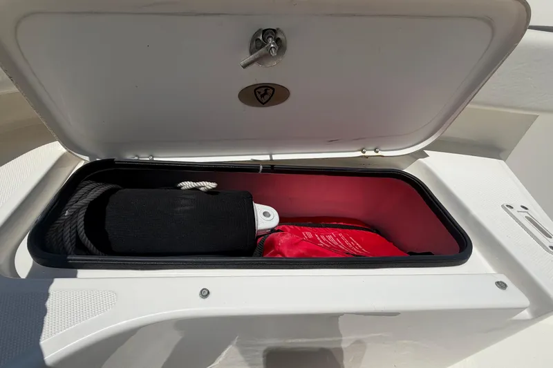 Slide: The Image of Open storage compartment on 2016 Century 2301 Center Console boat with rope and gear. - 54