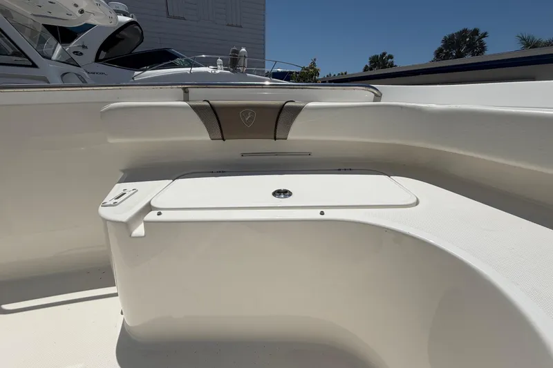 Slide: The Image of 2016 Century 2301 Center Console boat interior with seating and storage compartment. - 55