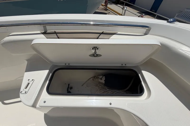 Slide: The Image of Open storage compartment on a 2016 Century 2301 Center Console boat. - 56