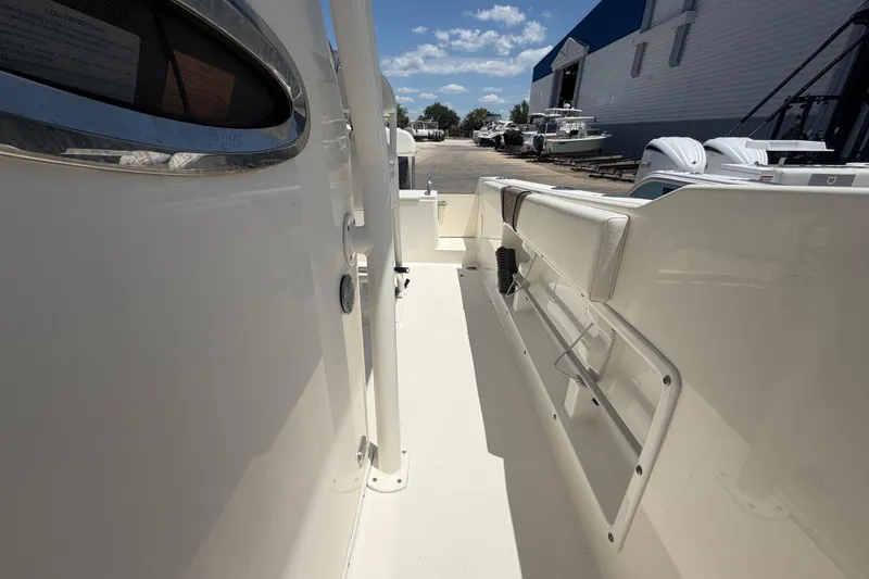 Slide: The Image of 2016 Century 2301 Center Console boat interior with seating and storage, docked under a clear sky. - 61