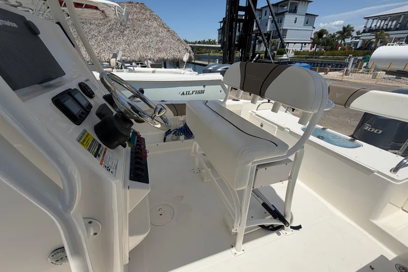 Slide: The Image of 2016 Century 2301 Center Console boat interior with steering wheel and seating. - 63