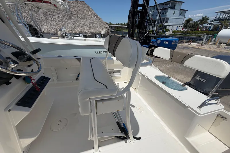 Slide: The Image of 2016 Century 2301 Center Console boat interior with seating and steering wheel. - 65