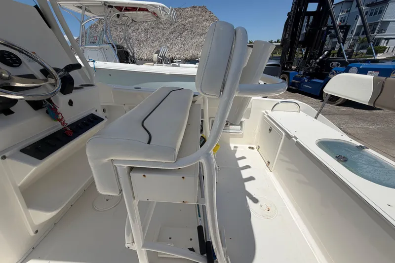 Slide: The Image of 2016 Century 2301 Center Console boat interior with seating and steering wheel. - 66