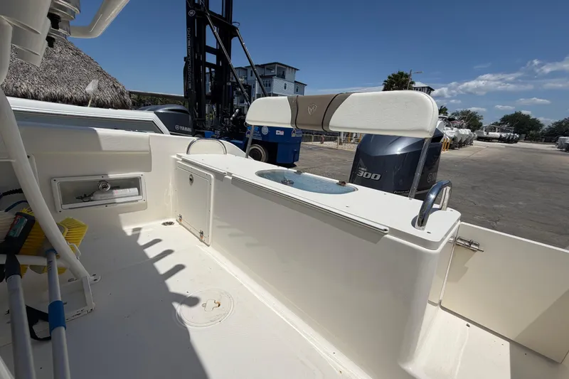 Slide: The Image of 2016 Century 2301 Center Console boat interior with Yamaha engine, docked under clear skies. - 67