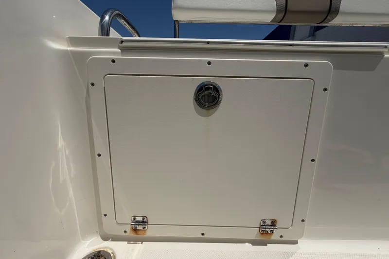 Slide: The Image of Hatch door on a 2016 Century 2301 Center Console boat, featuring a secure latch. - 72