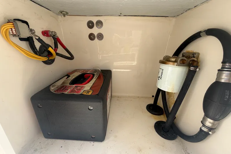 Slide: The Image of 2016 Century 2301 Center Console battery compartment with wiring and fuel filter. - 74