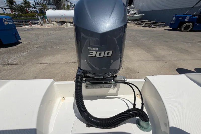 Slide: The Image of 2016 Century 2301 Center Console with Yamaha 300 engine in a marina setting. - 76