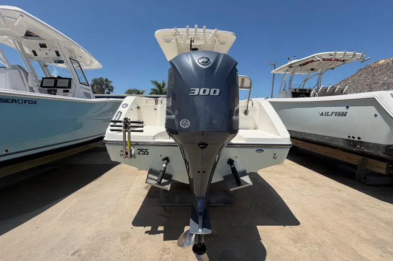 Slide: The Image of 2016 Century 2301 Center Console boat with Yamaha 300 engine, docked between other boats. - 8