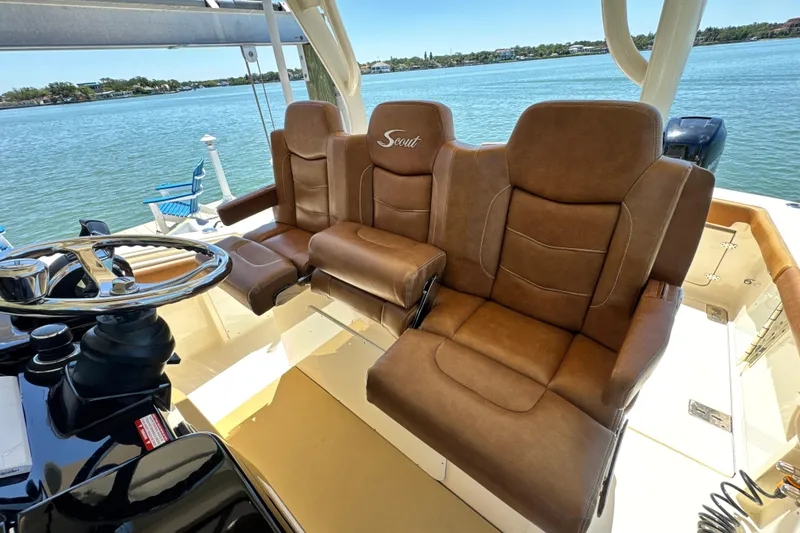 Slide: The Image of 2018 Scout 355 LXF boat interior with luxurious brown leather seating. - 20
