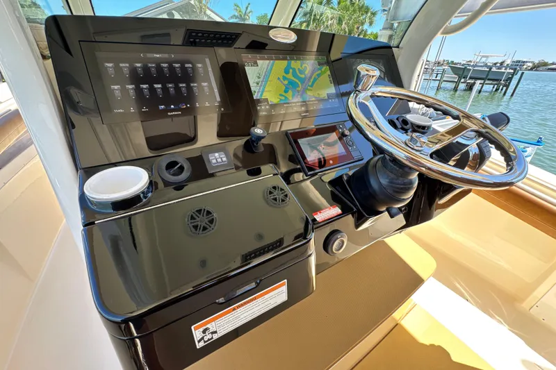 Slide: The Image of Helm of 2018 Scout 355 LXF boat with advanced navigation controls and steering wheel. - 22