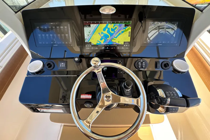 Slide: The Image of Helm of 2018 Scout 355 LXF boat with navigation screens and controls. - 23