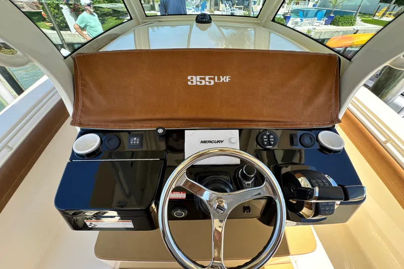Slide: The Image of 2018 Scout 355 LXF boat helm with Mercury controls and steering wheel. - 25