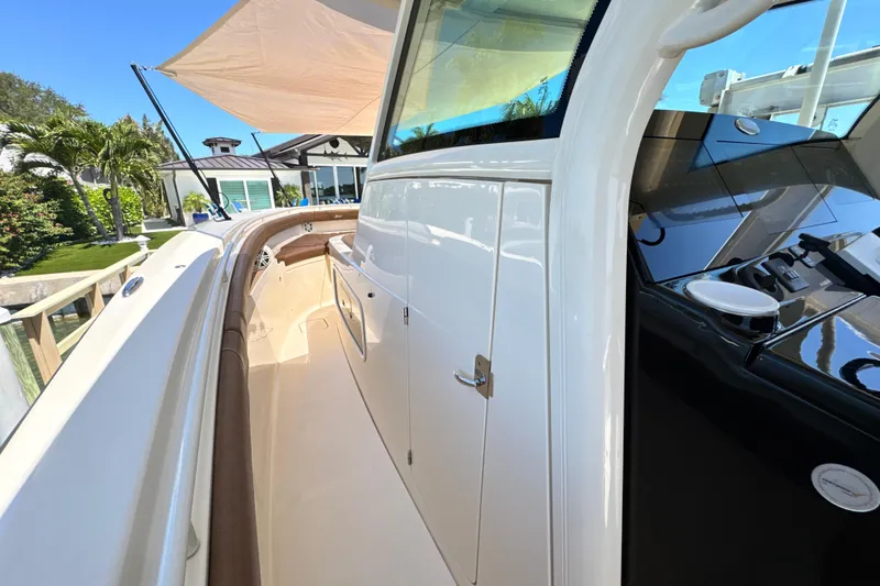 Slide: The Image of 2018 Scout 355 LXF boat with sleek white exterior and modern design features. - 26