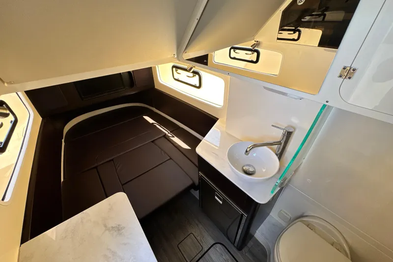Slide: The Image of 2018 Scout 355 LXF cabin interior with bed, sink, and storage. - 40