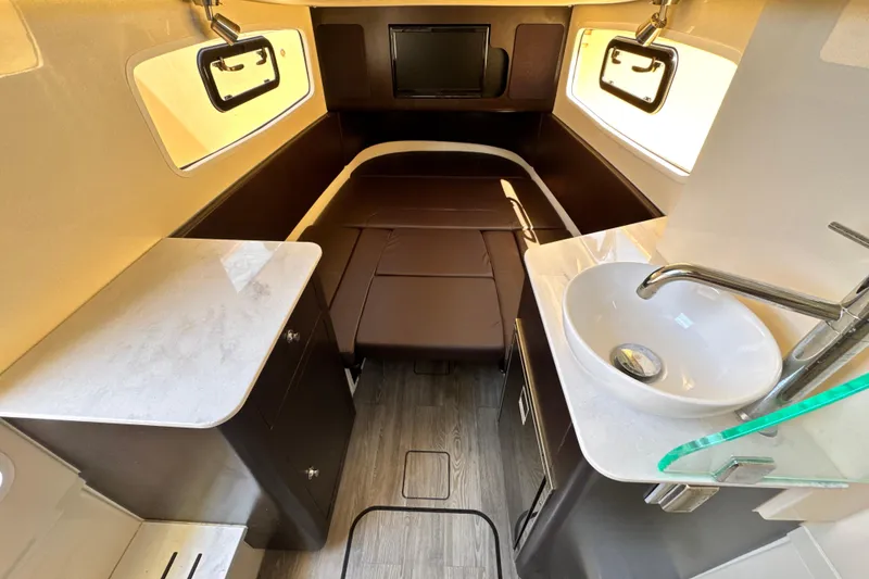 Slide: The Image of 2018 Scout 355 LXF cabin interior with bed, sink, and modern amenities. - 41