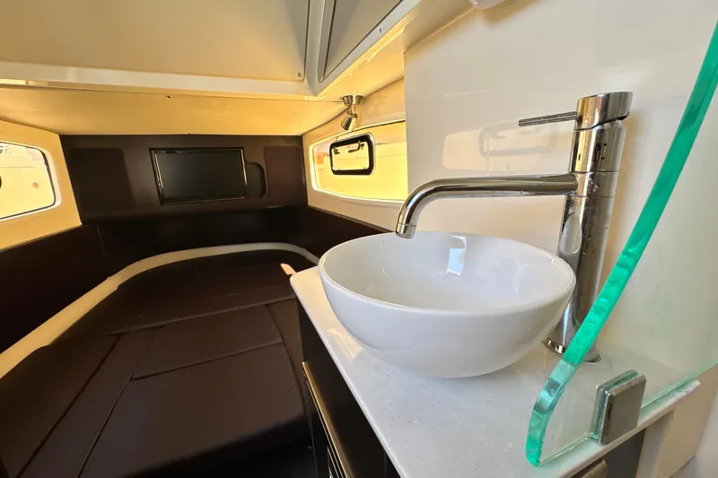 Slide: The Image of Interior of 2018 Scout 355 LXF boat with modern sink and cozy sleeping area. - 42