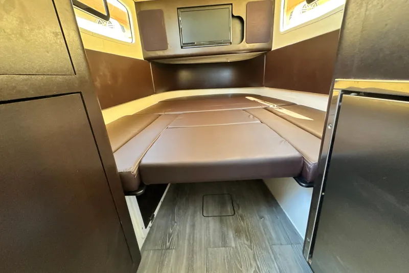 Slide: The Image of 2018 Scout 355 LXF cabin interior with brown leather seating and wood flooring. - 43