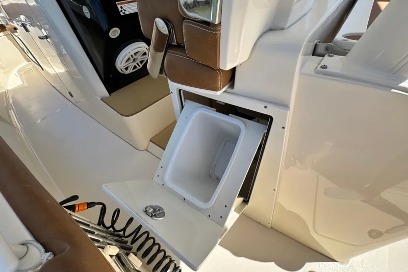 Slide: The Image of 2018 Scout 355 LXF boat interior with open storage compartment and seating. - 50