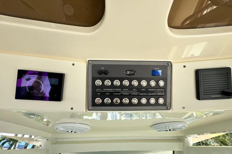 Slide: The Image of Control panel of a 2018 Scout 355 LXF boat with digital displays and switches. - 52