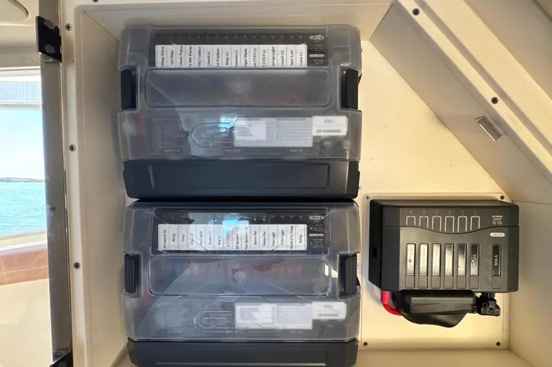 Slide: The Image of Electrical panel inside a 2018 Scout 355 LXF boat, featuring labeled circuit breakers. - 54
