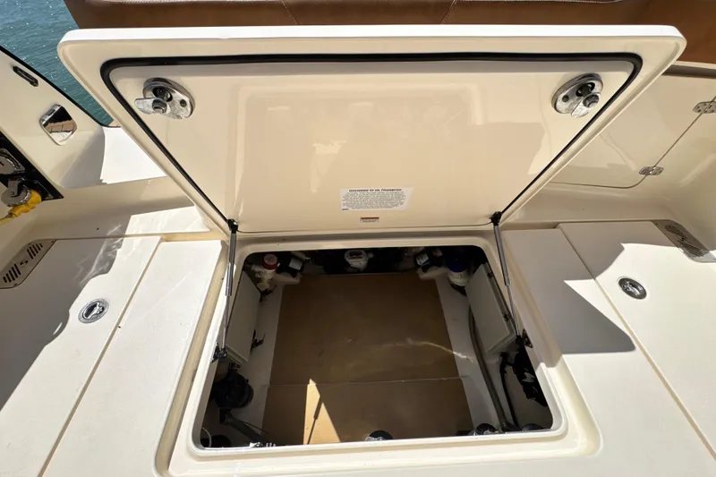 Slide: The Image of Open storage compartment on 2018 Scout 355 LXF boat, showcasing interior space. - 55