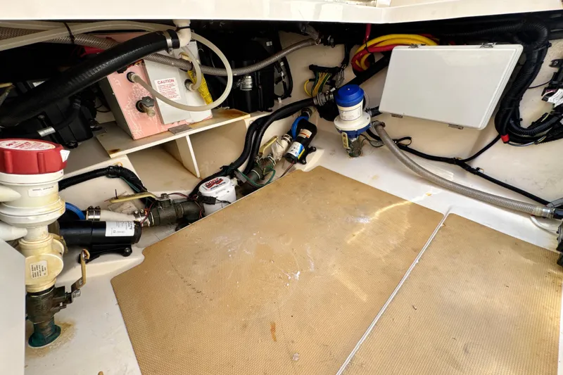 Slide: The Image of Engine compartment of a 2018 Scout 355 LXF boat, showcasing various mechanical components. - 56