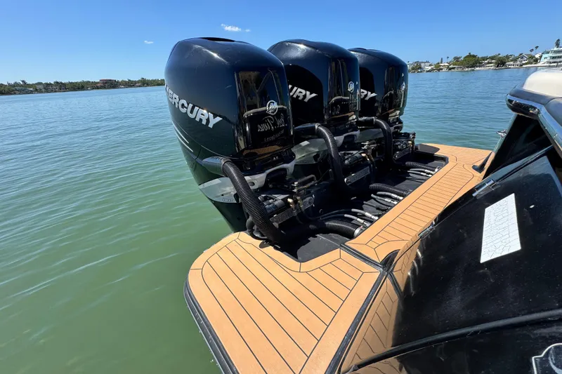 Slide: The Image of 2018 Scout 355 LXF boat with triple Mercury outboard engines on water. - 6