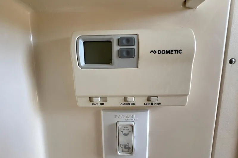 Slide: The Image of Control panel of a 2018 Scout 355 LXF boat with electrical switches and stereo system. - 60