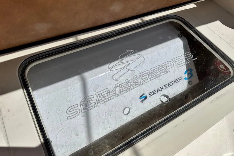 Slide: The Image of Open storage compartment on 2018 Scout 355 LXF boat, showcasing interior space. - 62