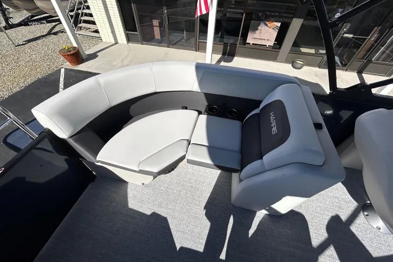 Slide: The Image of 2026 Harris Cruiser 230 CWDH boat interior with plush seating and cup holders. - 15