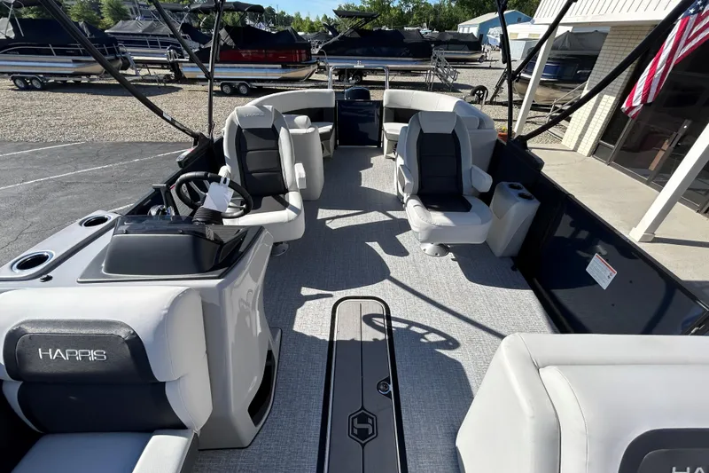 Slide: The Image of 2026 Harris Cruiser 230 CWDH pontoon boat interior with seating and steering console. - 16