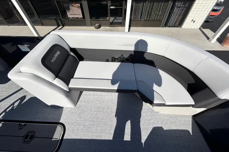 Slide: The Image of 2026 Harris Cruiser 230 CWDH boat interior with gray seating and cup holders. - 17