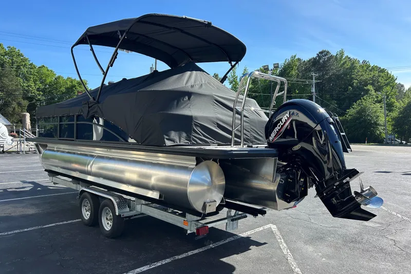 Slide: The Image of 2026 Harris Cruiser 230 CWDH pontoon boat on trailer, covered and parked outdoors. - 23